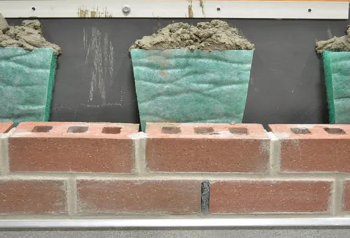 MortarNet with Insect Barrier suspending mortar droppings above the flashing